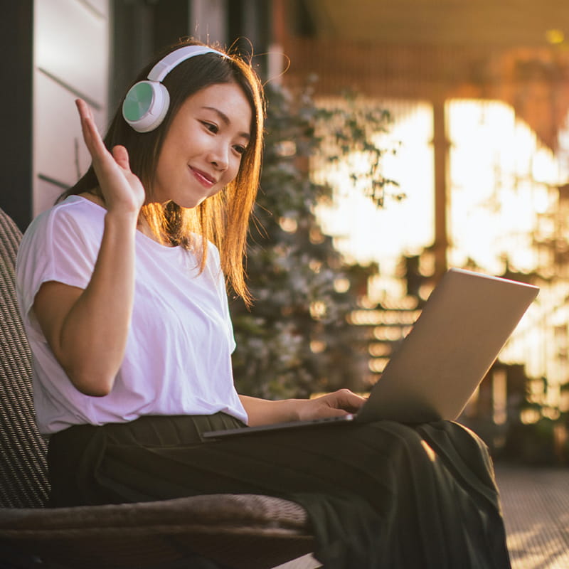 woman on headphones using computer