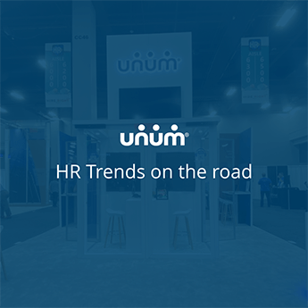 A booth with stools and microphones with the Unum logo above at a conference. The words "HR Trends on the Road" appear over the image.