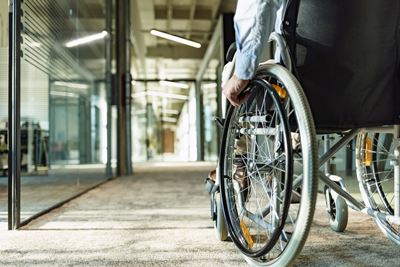 A person in a wheelchair enters an office