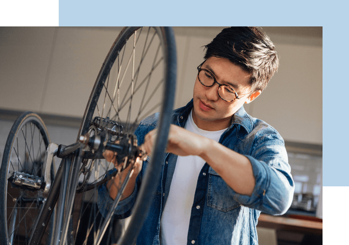 Image of male working on a bicycle