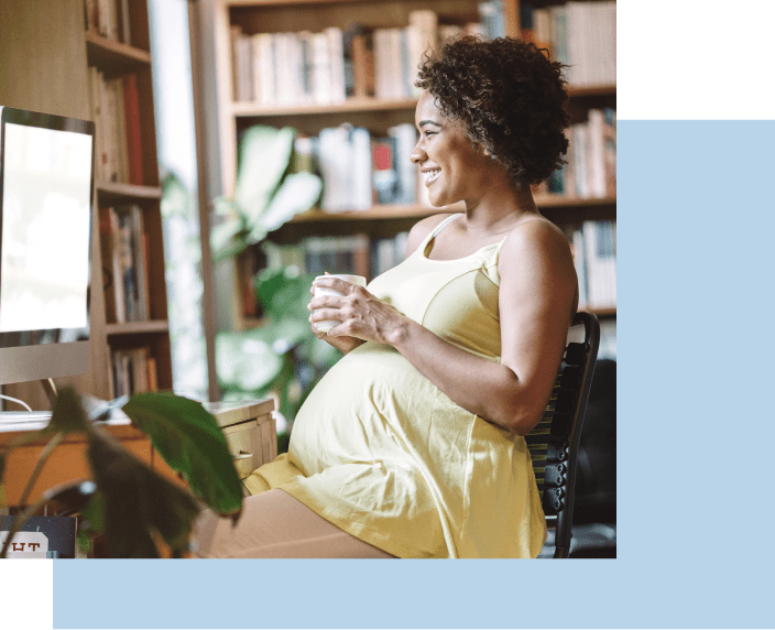 Pregnant woman smiling at screen