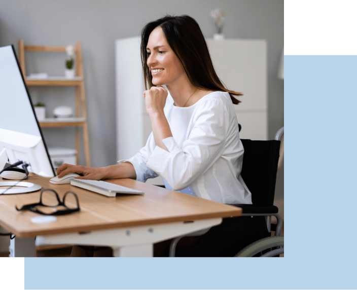 Woman smiling while looking at computer screen