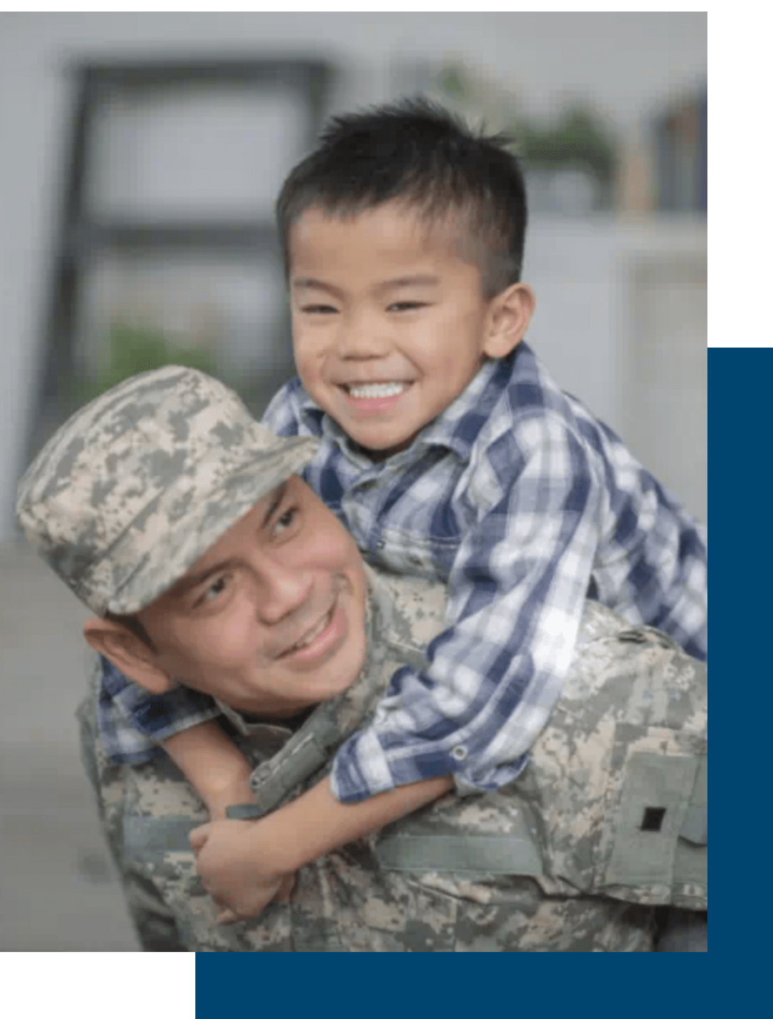 Military father carrying son on his shoulders