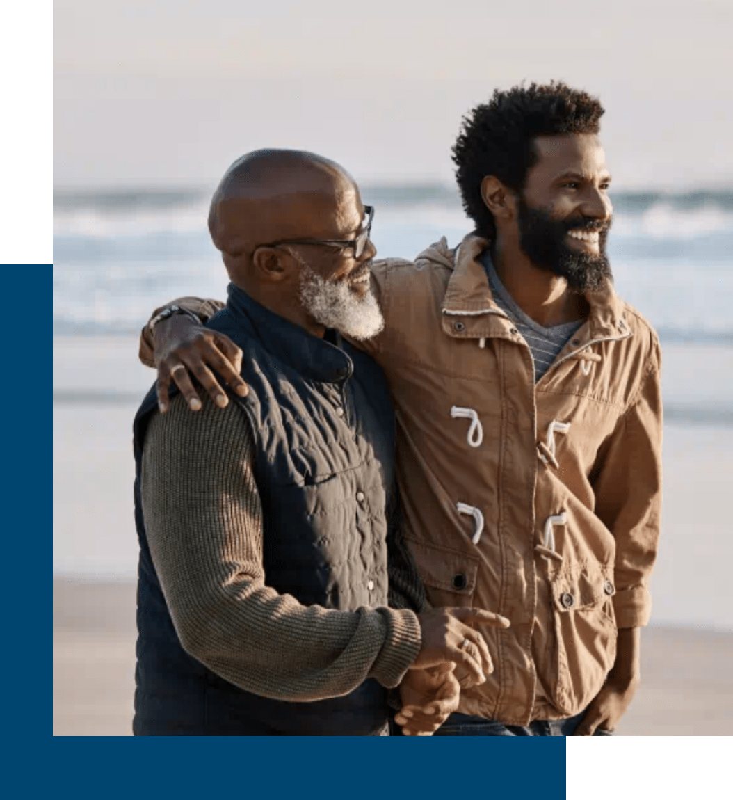 Father and son smiling at the beach