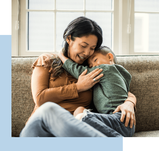 Mother and son hugging and smiling happily